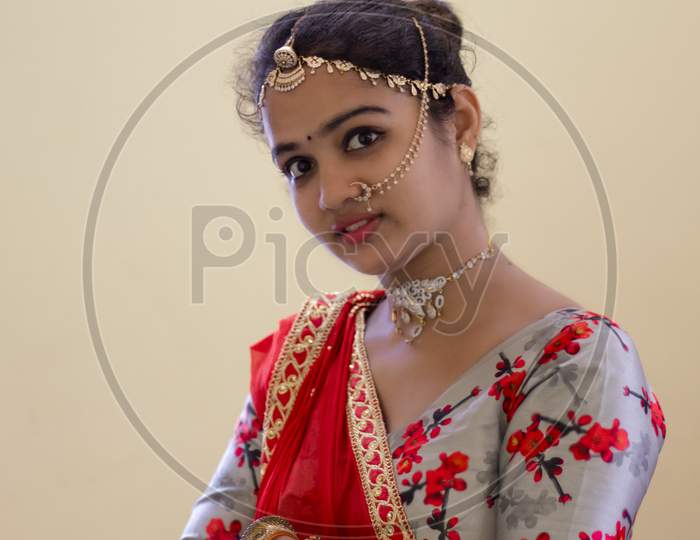 A Beautiful Young Hindu Girl With Gold Ornaments And Red Lipstick On Her Attractive Soft Lips