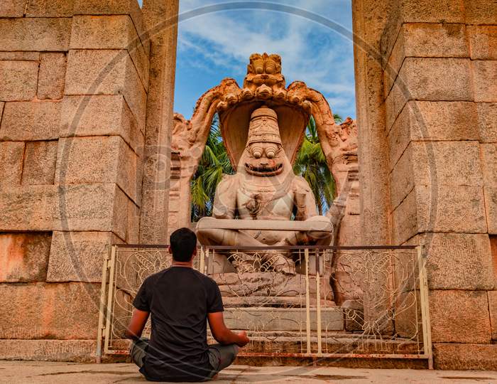 Man Meditating At Narasimha Lakshmi Temple Hampi Antique Stone Art Close Up Shot