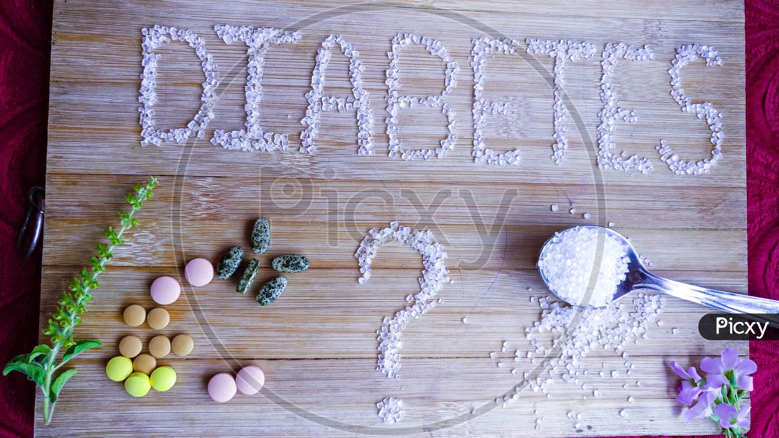 Diabetes written by sugar on wooden table.full spoon of sugar, tablets, Basil
