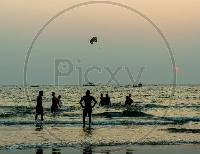 Tourists enjoying the beach of goa Parasailing at Goa Beach