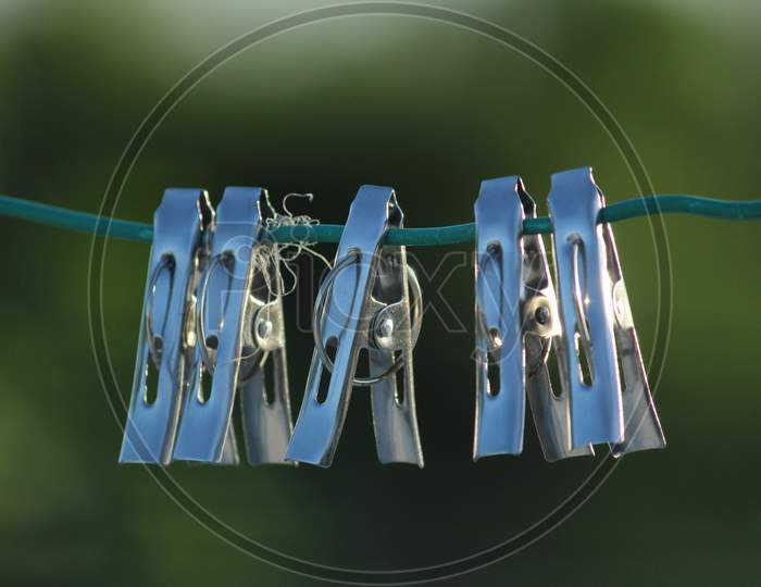 Group Of Color And Stainless Steel Clips Hang On The Rope Without Clothes