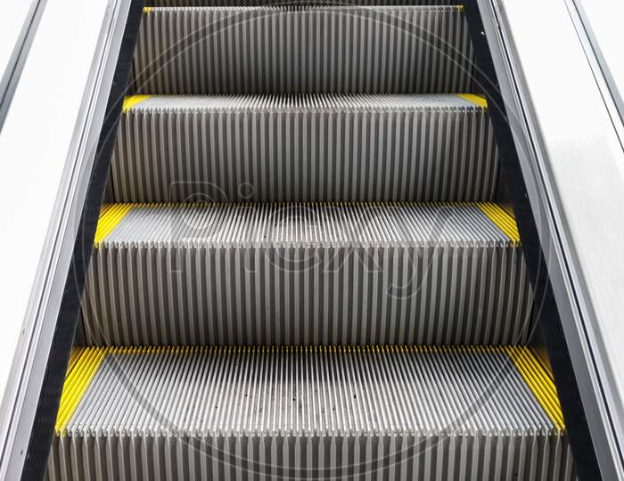 Close Up Of Empty Steps Of An Escalator In A Perspective View.