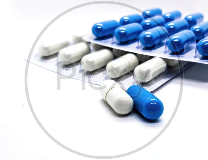 Close Up A Supplements Medicine Capsules Of White And Blue Colors Against White Background