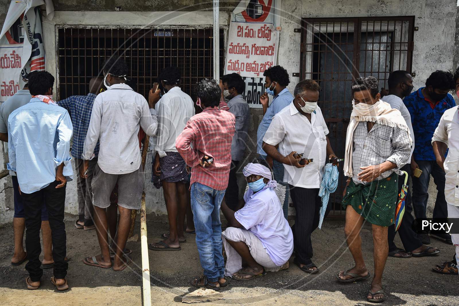 People Flout Social Distancing As They Wait To Buy Liquor Outside A Wine Shop, At Mandadam In Guntur District, August 02, 2020.