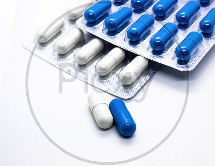 Close Up A Supplements Medicine Capsules Of White And Blue Colors Against White Background