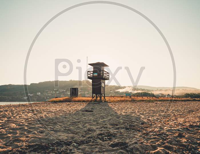 A Lifeguard Tower In The Beach During A Sunrise