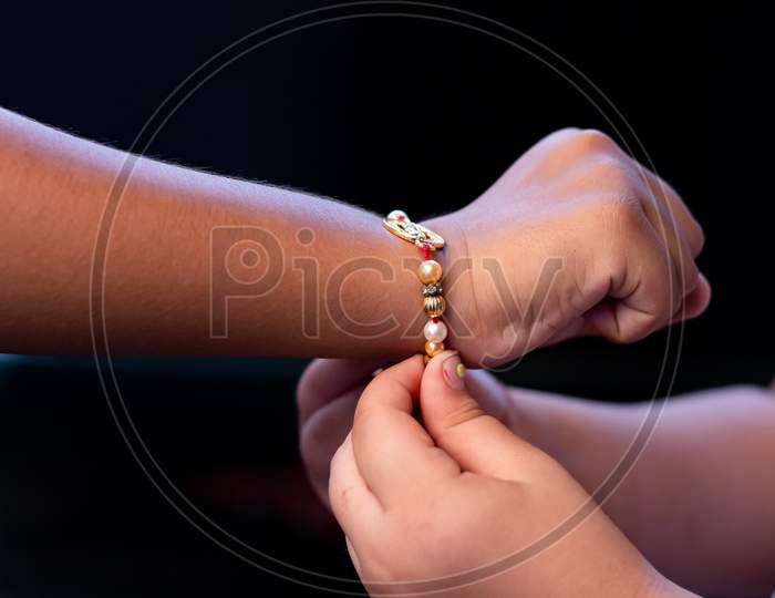 Girl tying Rakhi on Brother's Hand. Raksha Bandan  Indian Festival Brother and sister