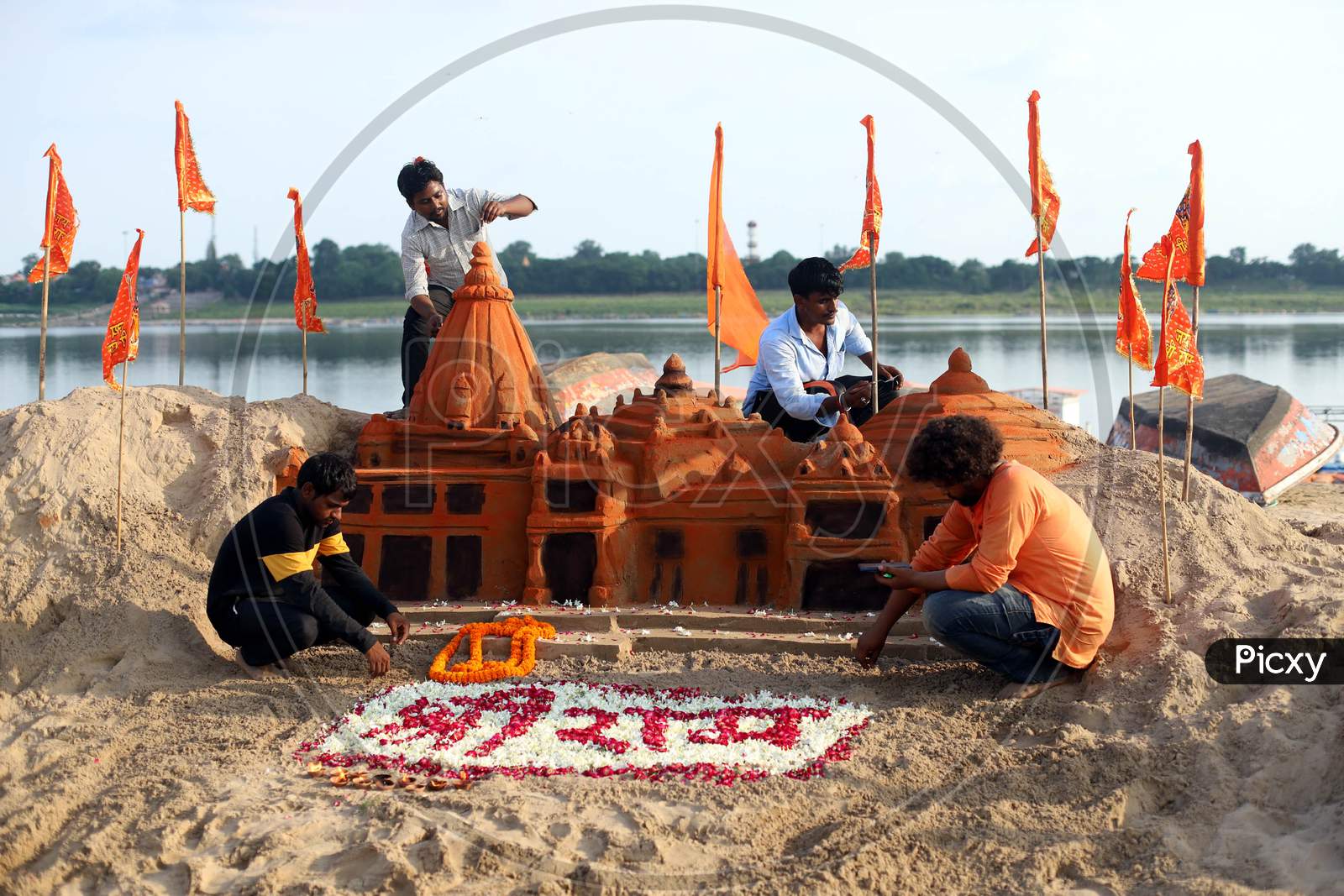 Allahabad Central University students built a sand sculpture of Ram Temple, ahead of the foundation ceremony of Ram temple in Ayodhya, on the banks of River Ganga at Sangam, in Prayagraj, August 4, 2020.