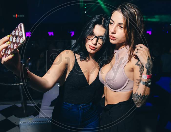 Two latin girls in party taking a selfie