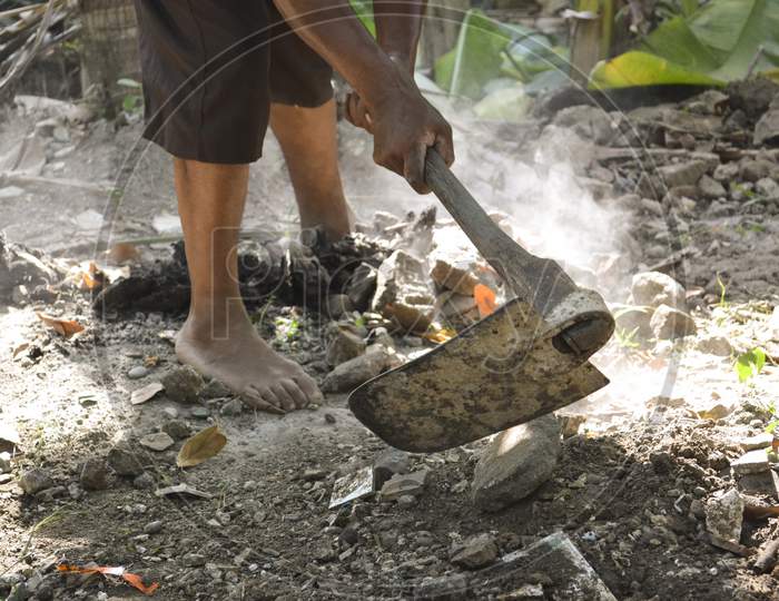 Dustman Cleaning Dry Leaf Litter Using A Hoe
