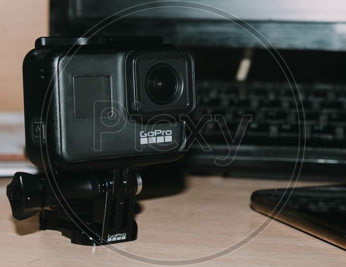 Delhi, India - April 30 2020: Action Camera In Mount Stand Clipping Clamp On Table, Gopro Hero 7 Black