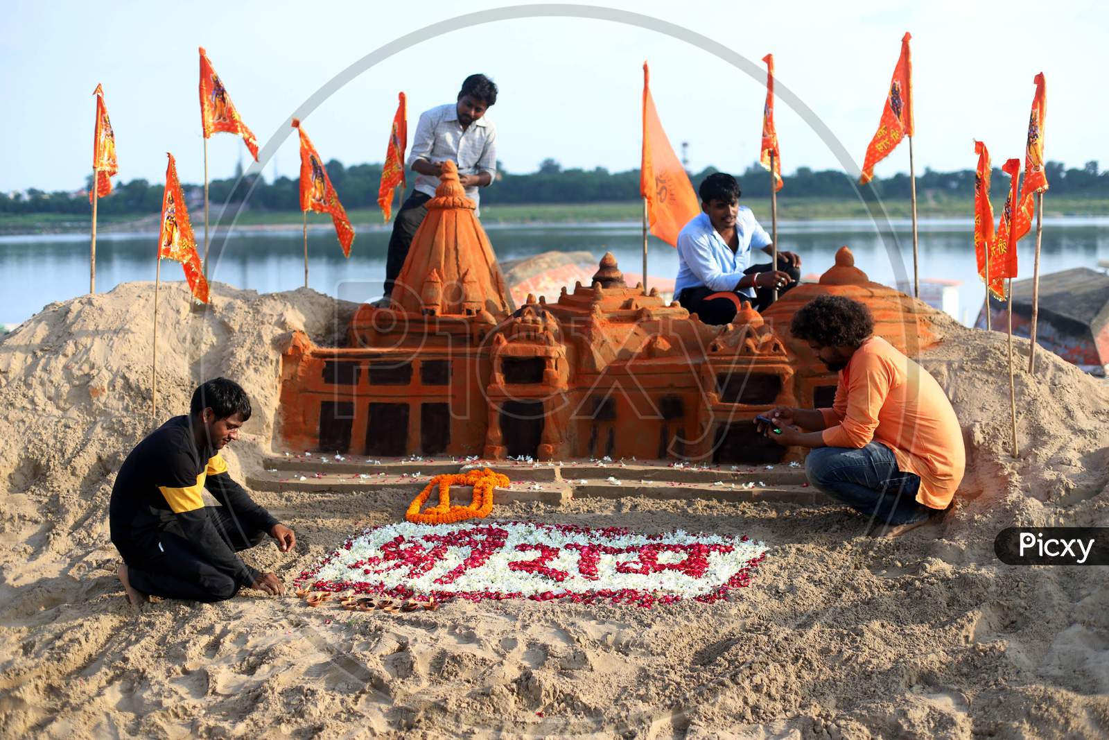 Allahabad Central University students built a sand sculpture of Ram Temple, ahead of the foundation ceremony of Ram temple in Ayodhya, on the banks of River Ganga at Sangam, in Prayagraj, August 4, 2020.