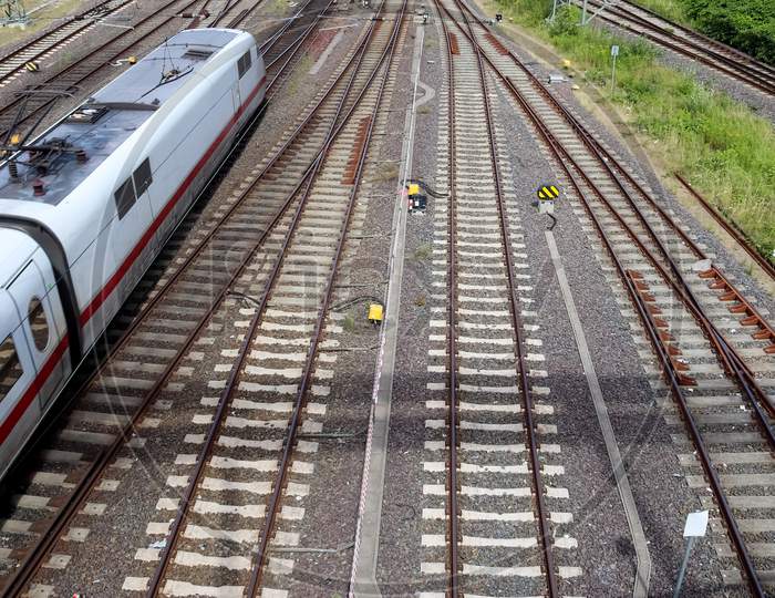 Multiple Railroad Tracks With Junctions At A Railway Station In A Perspective And Birds View