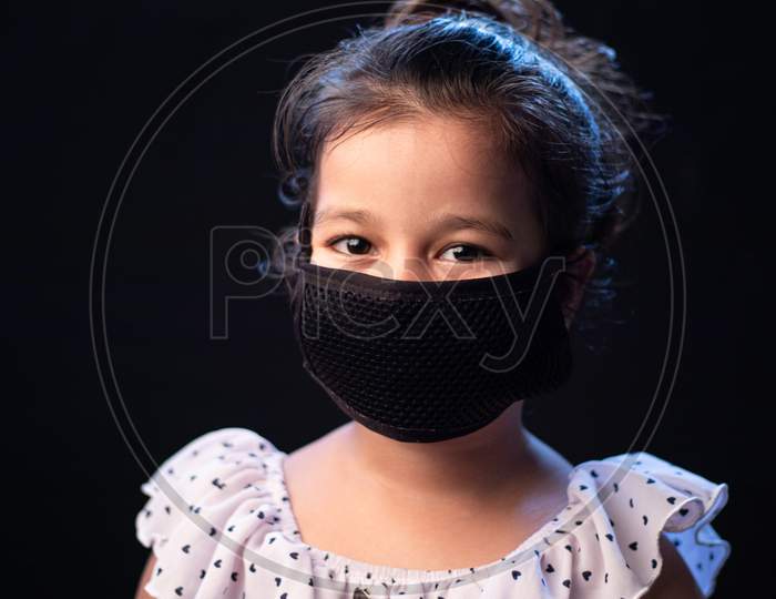 Indian Girl Child Smile With Face Mask On Black Background