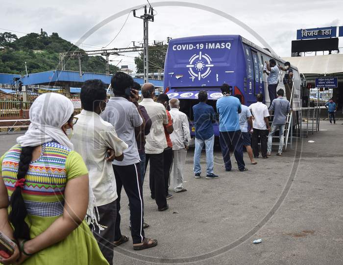 People Wait Near The Mobile Swab Collection Vehicle For The Covid-19 Test, At Vijayawada Railway Station, In Vijayawada, August 04, 2020.