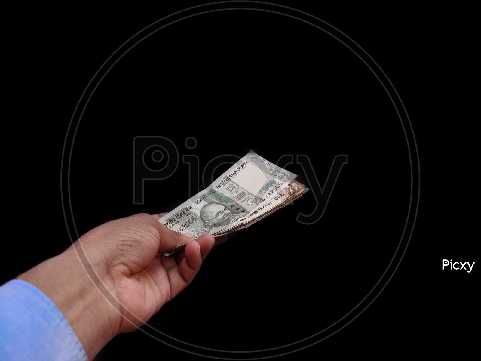 Banknote currency in hand of man , isolated on black background.