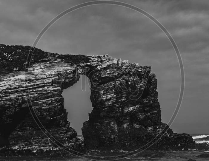 A Dramatic Shot Of A Cliff In The Spanish Coast In Black And White