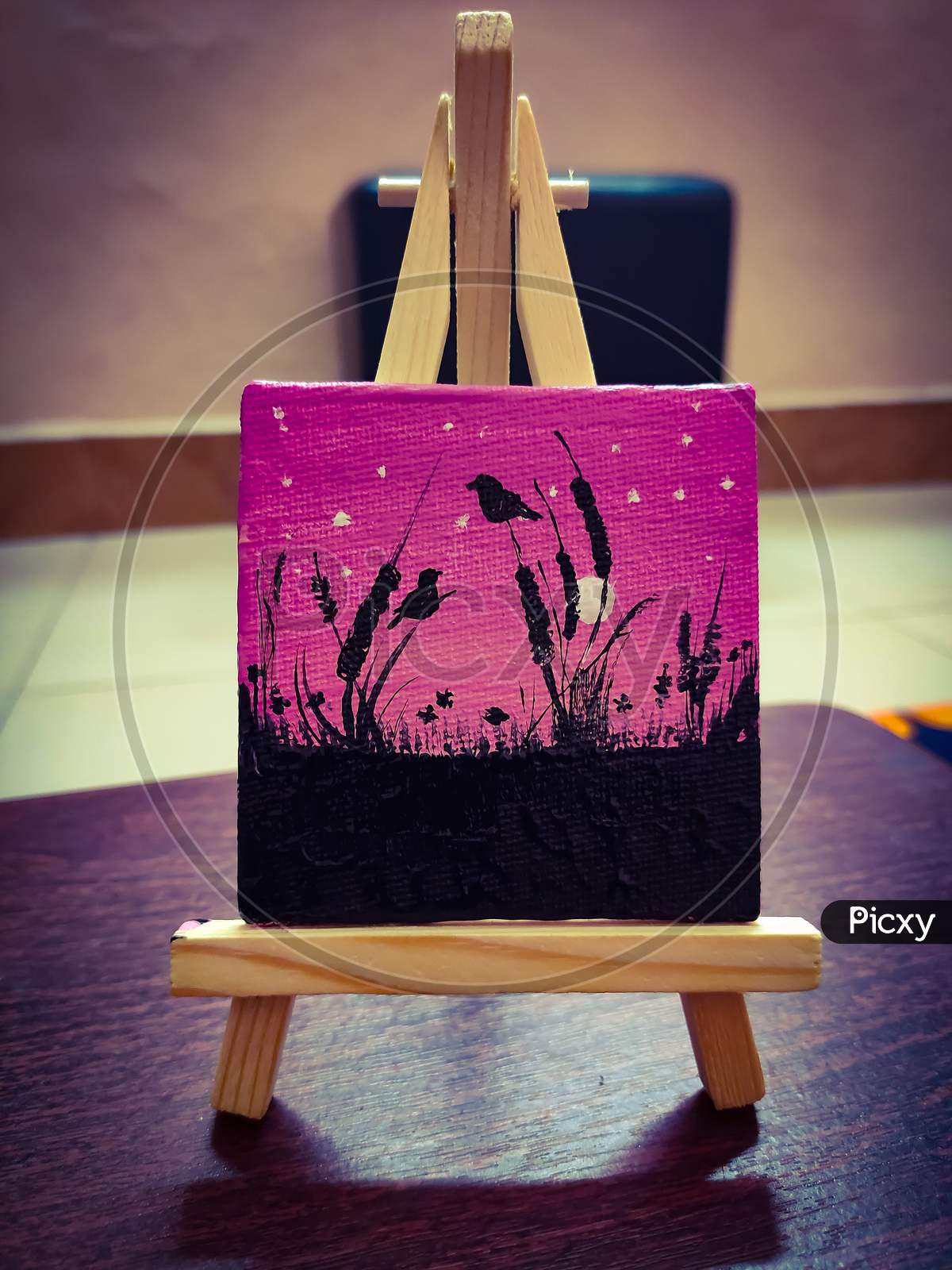 A beautiful mini acrylic painting on 3 by 3" canvas on easle stand.