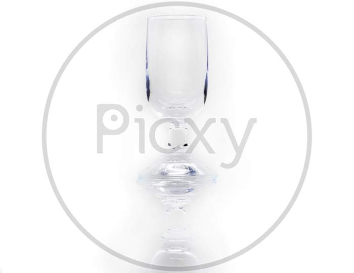 An Abstract Background Image Of An Antique Wine Glass Against White Background