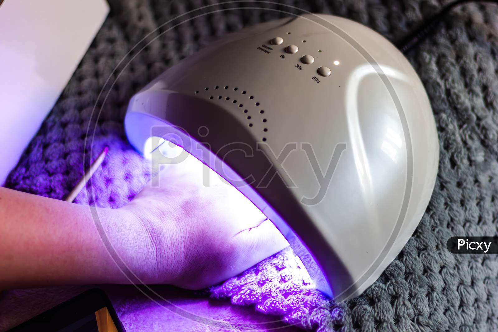 Caucasian Female Does Self Nail Polish Drying By Using Uv Led Technique