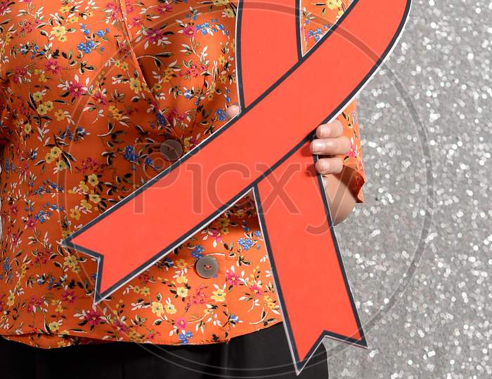 Woman holding a red ribbon large board