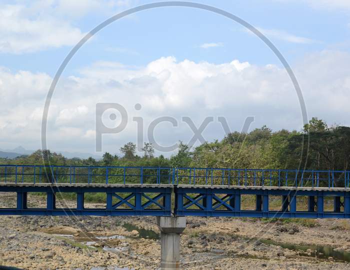 Coudy Blue Sky Over The Iron Bridge In Blue Paint During The Day