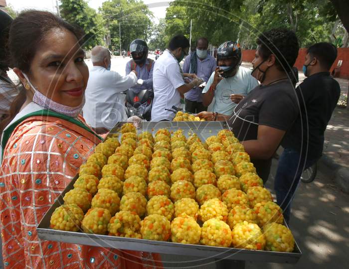 Activists of youth congress distributing sweets at a market in Chandigarh, during the celebrations of the stone laying ceremony of the Ram Temple in Ayodhya, August 5, 2020.