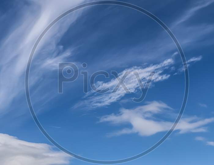 Stunning cirrus cloud formation panorama in a deep blue sky