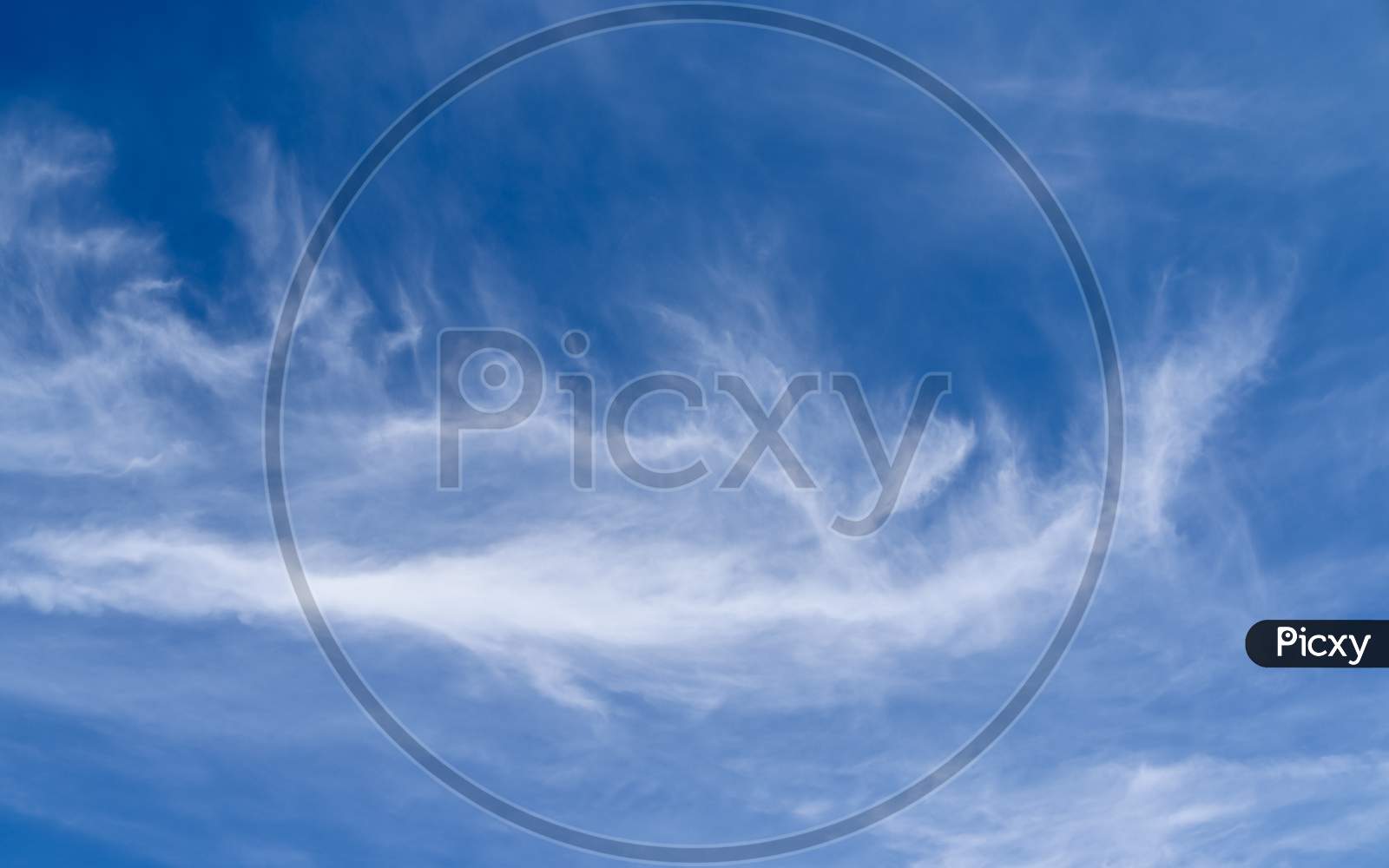 Stunning cirrus cloud formation panorama in a deep blue sky