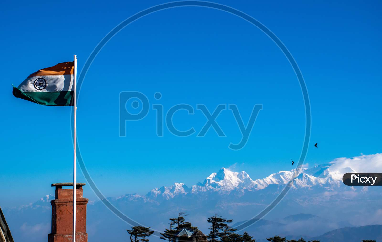 The Indian flag is waving in the sky at Eastern Himalayan mountain range or mount kancehnjunga range in Sandakfu Westbengal India