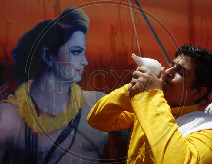 A boy blows a conch shell at BJP local office during the celebrations of the stone laying ceremony of the Ram Temple by Prime Minister Narendra Modi in Ayodhya, in Chandigarh, August 5 , 2020
