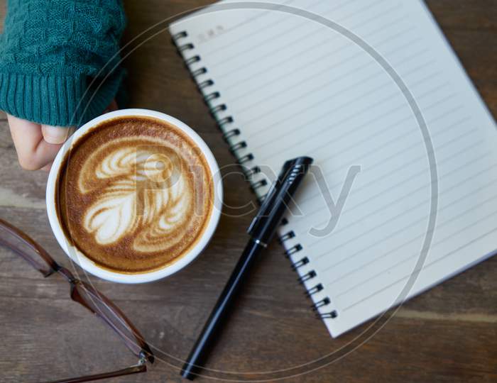 hot coffee with notebook