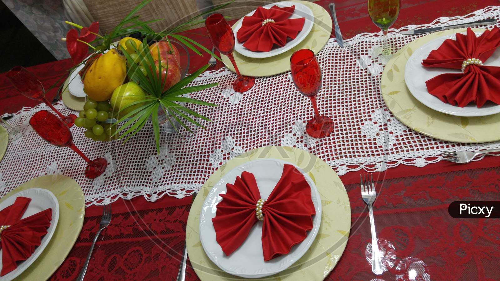 A traditional table for Christmas dinner with decorated dishes and fruits