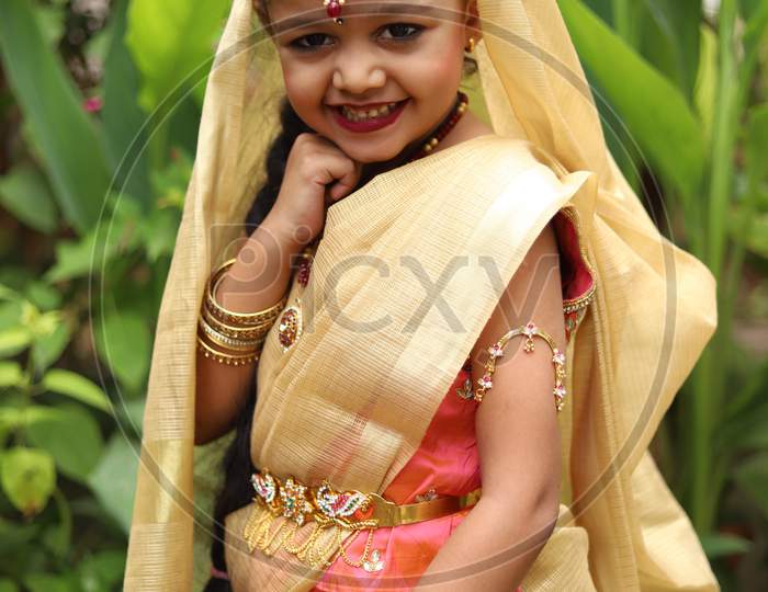 Cute little girl dressed in traditional Indian sari to celebrate Indian festivals.