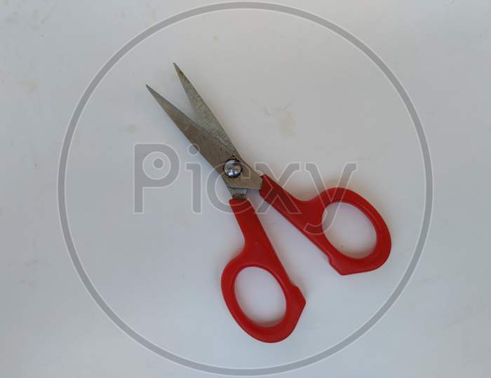Steel and Red Color Small Single Scissor isolated on white Background