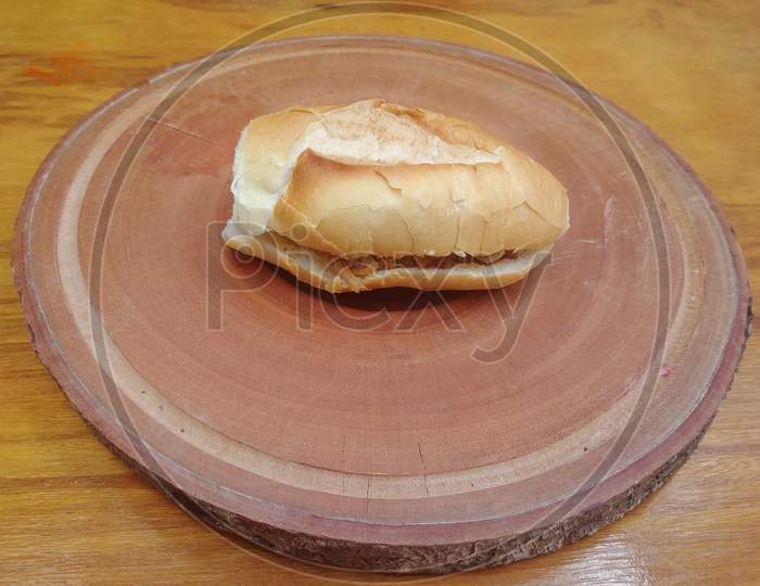 Brazilian bread with meat on wooden base