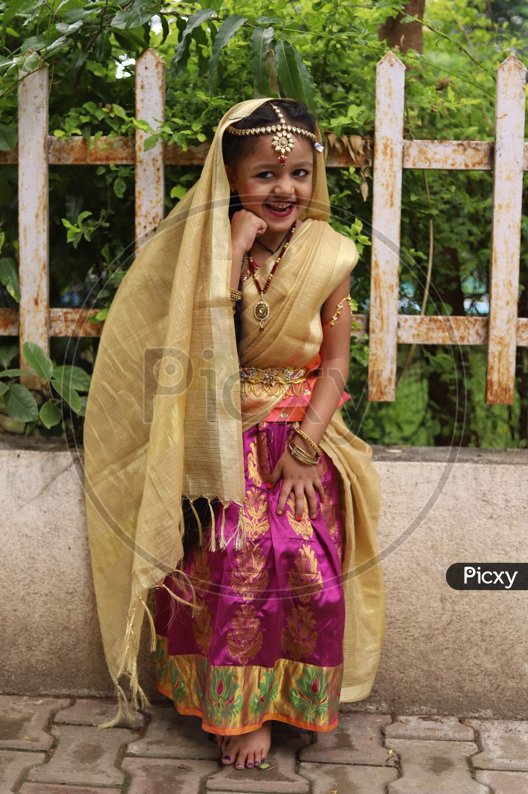 Cute little girl dressed in traditional Indian sari to celebrate Indian festivals.