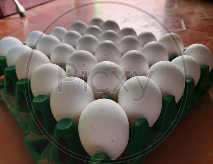 Eggs arranged orderly in a tray