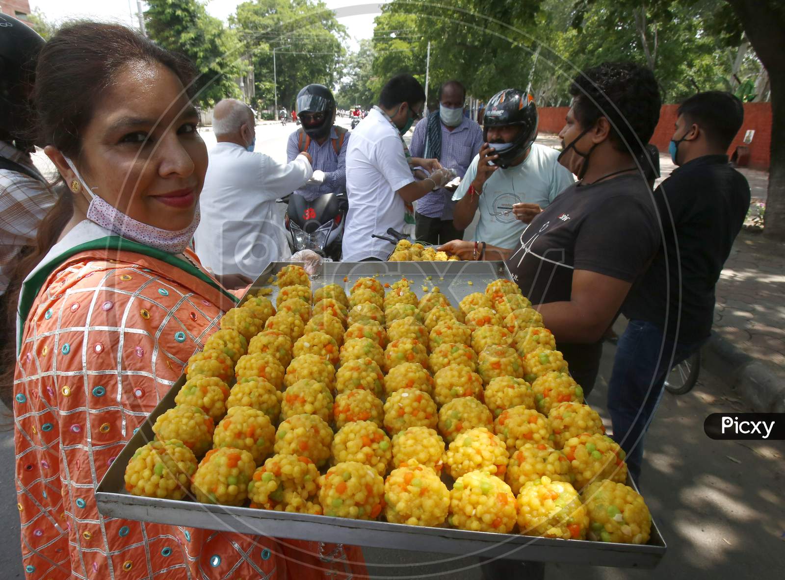 Activists of youth congress distributing sweets at a market in Chandigarh, during the celebrations of the stone laying ceremony of the Ram Temple in Ayodhya, August 5, 2020.