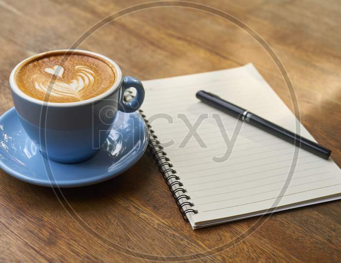hot coffie with notebook