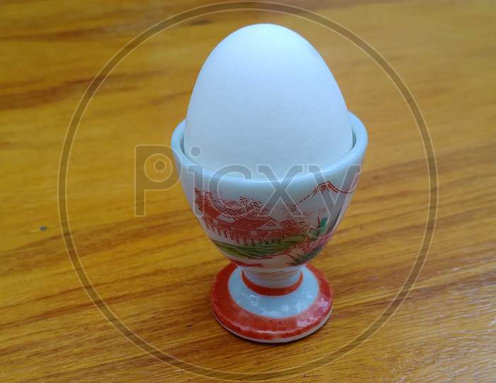 Delicate boiled egg holder on the wooden table