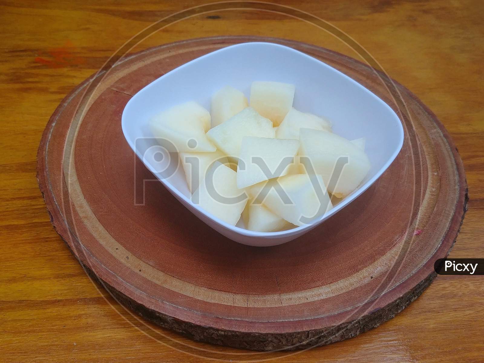 Delicious pieces of melon in a square bowl