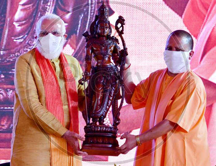 Prime Minister Narendra Modi and Uttar Pradesh Chief Minister Yogi Adityanath hold an idol of Hindu Lord Ram after the foundation laying ceremony for a Ram's temple, in Ayodhya, India, August 5, 2020.