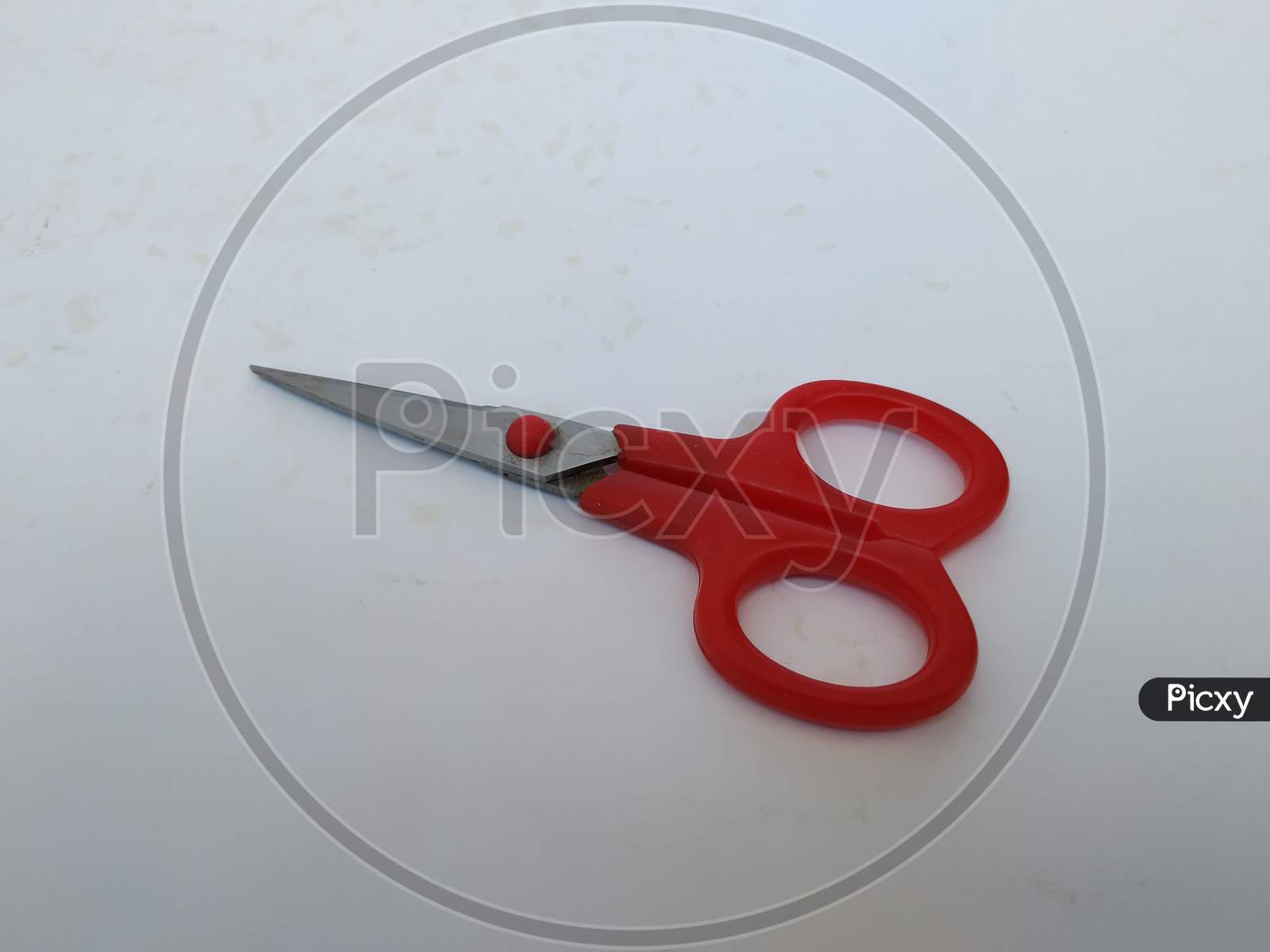 Steel and Red Color Small Single Scissor isolated on white Background