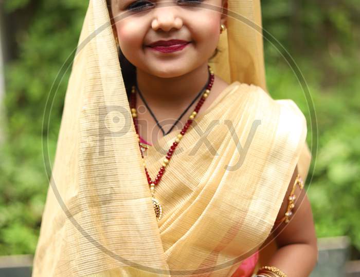 Cute little girl dressed in traditional Indian sari to celebrate Indian festivals like Krishna Janmashtami ,Diwali or Holi.