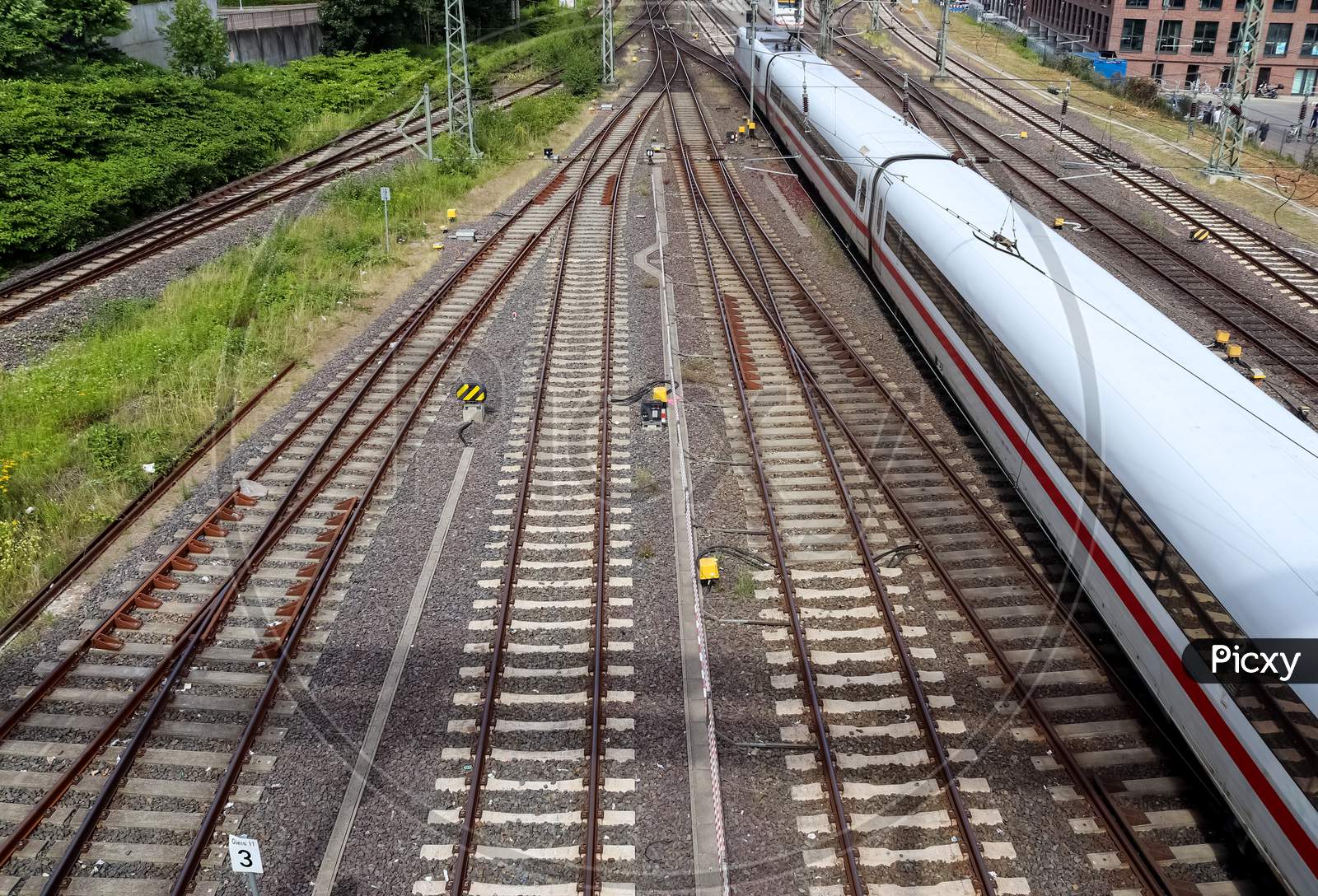 Multiple Railroad Tracks With Junctions At A Railway Station In A Perspective And Birds View
