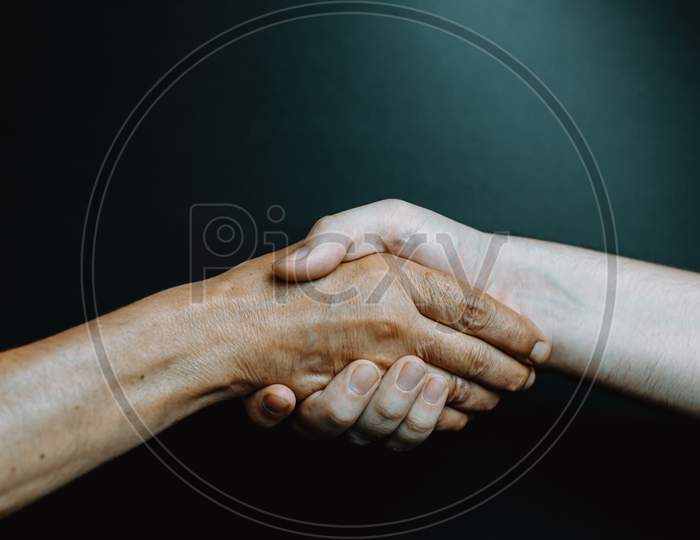 Old Latina Woman And Young Boy Hand Shaking Hands