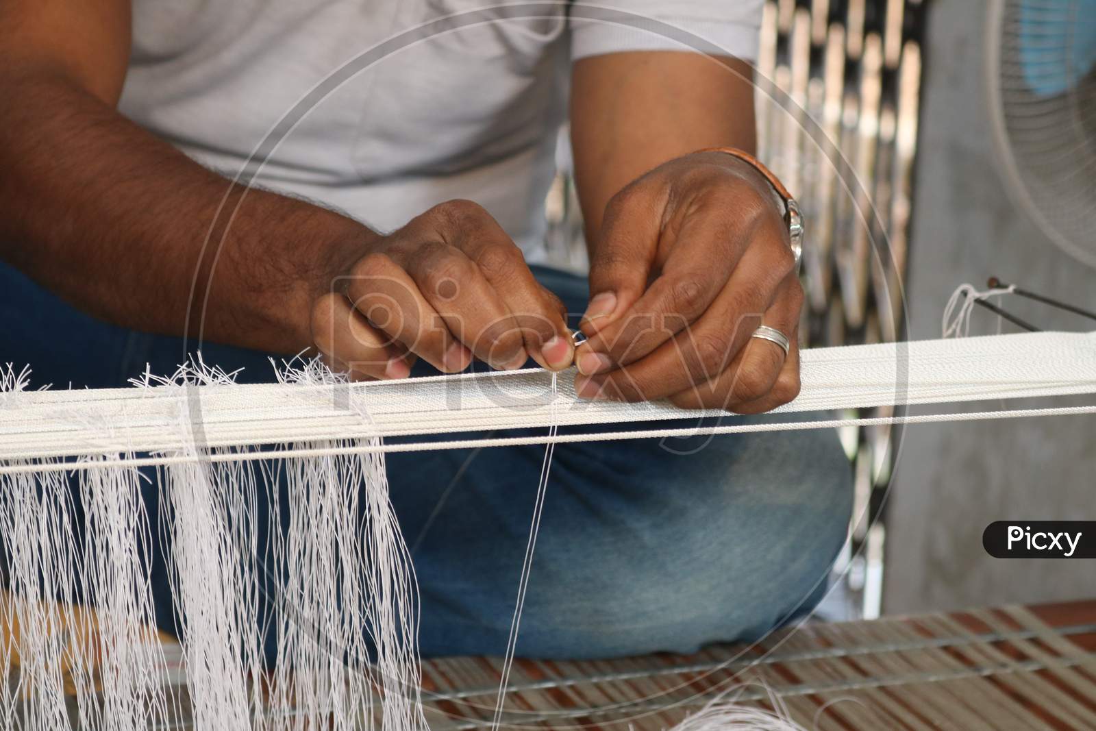 Handloom weaver in India working in his loom.