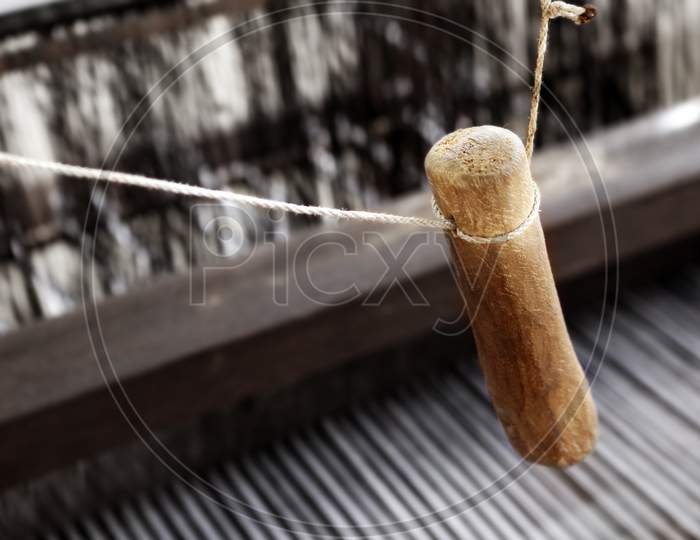 'Picker' a handloom  mechanism used to through the shuttle with weft yarn to weave a fabric.