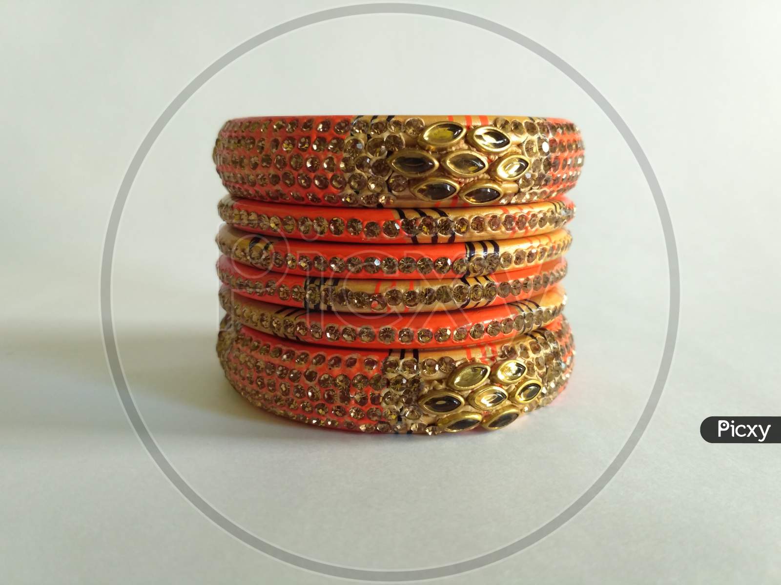 Stack Of Gold Bangle With Vivid Color And Rhinestone Isolated On White Background